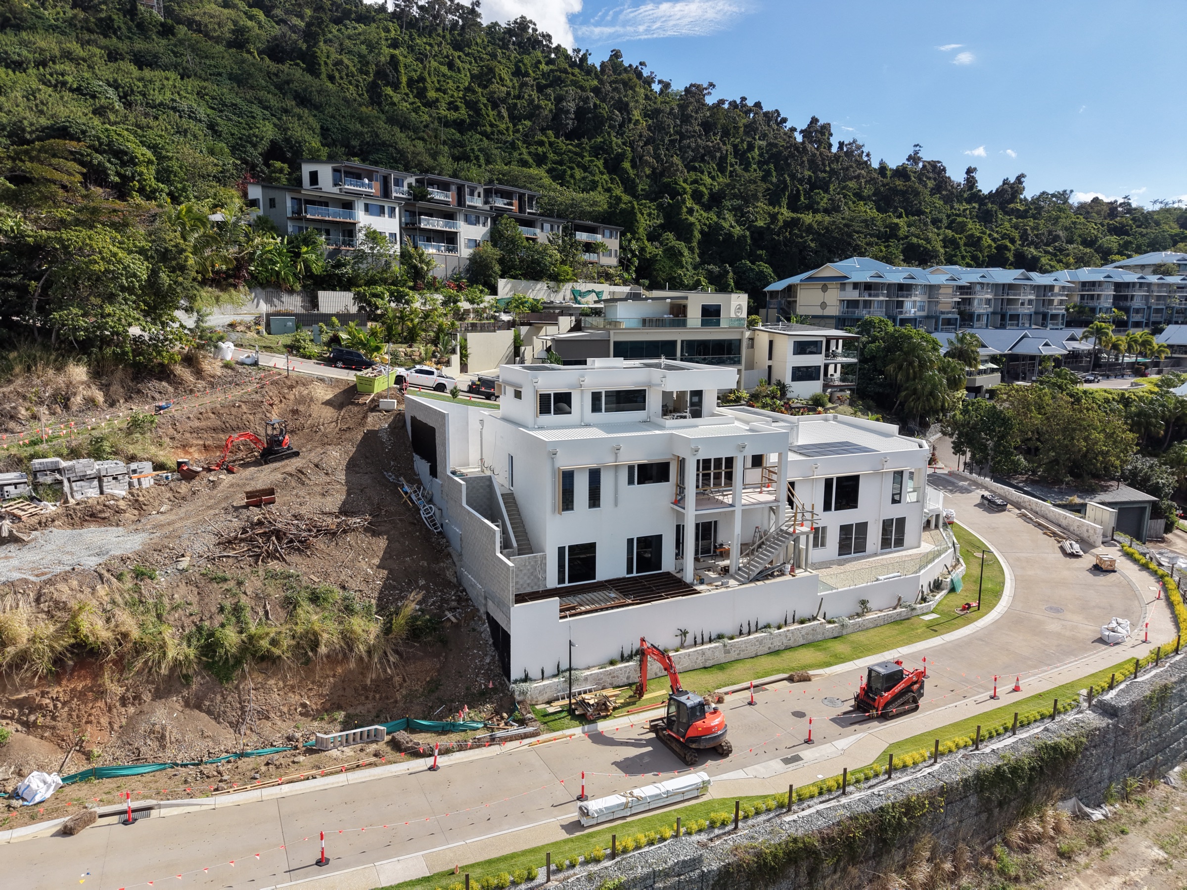 Angled construction progress view showing the building and surrounding works